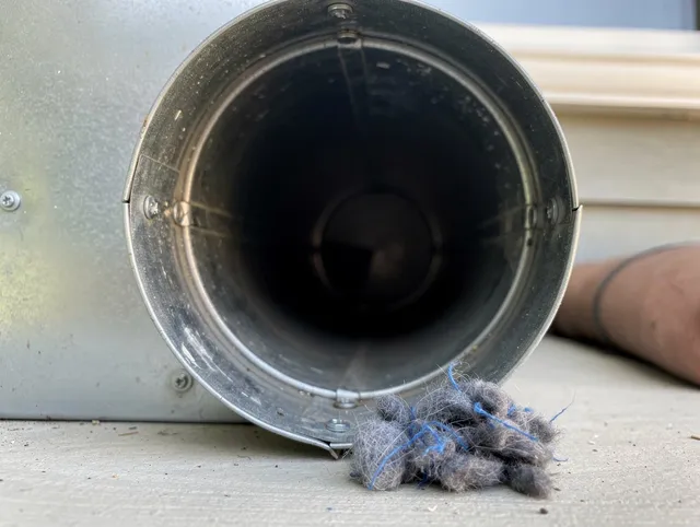Doral Dryer Vent Cleaning technician using specialized equipment to clear severe dryer vent blockage in Doral